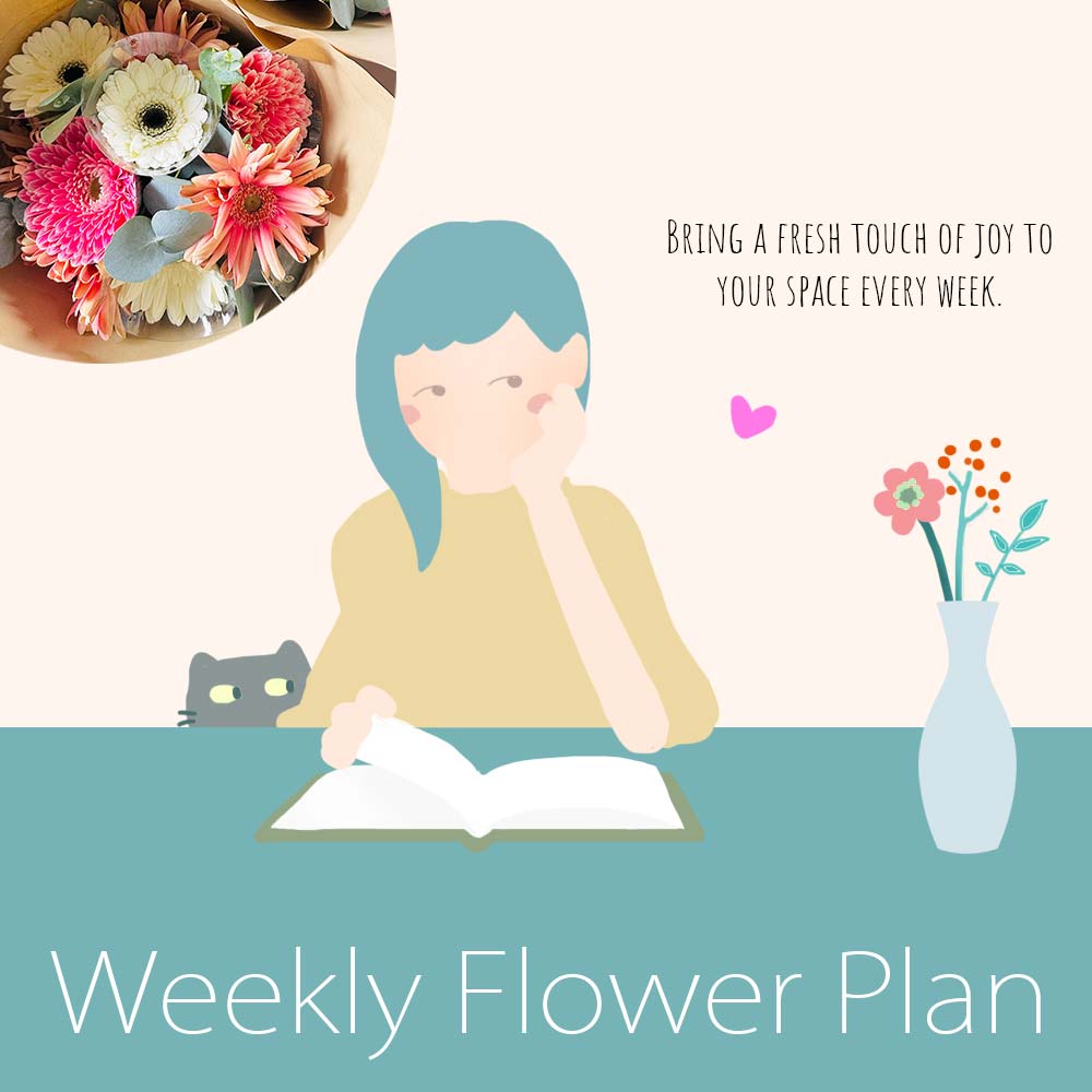 A girl and a cat are attracted by a little flower arrangement in a vase